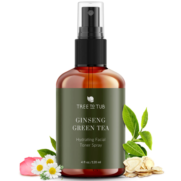 A brown spray bottle labeled Tree to Tub Ginseng Green Tea Hydrating Facial Toner Spray sits surrounded by green leaves, pink flowers, ginseng slices, and green tea leaves. The bottle contains 4 fl oz (120 ml).