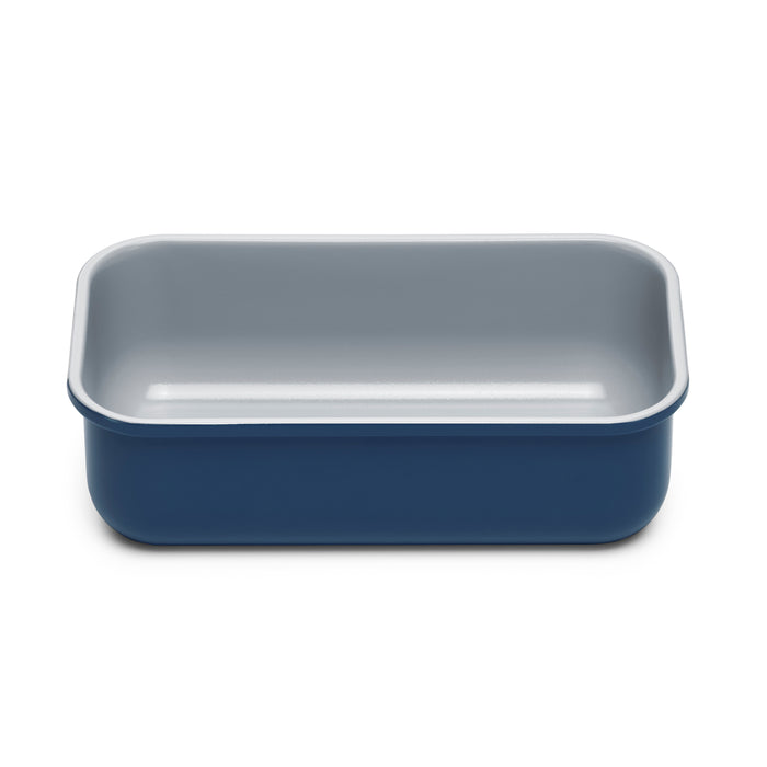 A rectangular blue baking dish with rounded corners and a light gray interior, viewed from the front against a white background.