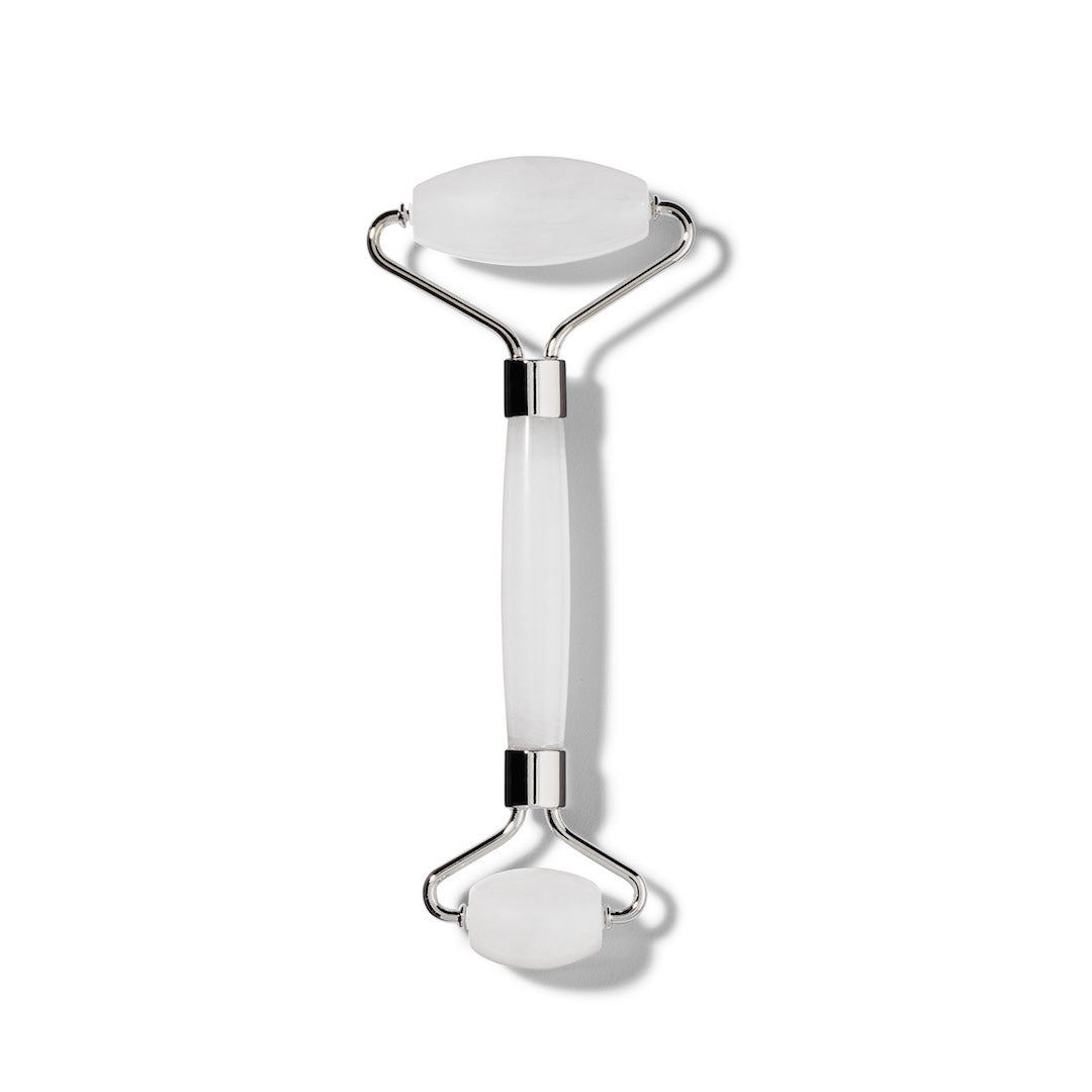 The Terra Beauty Bars Frosted Quartz Facial Roller features dual-sized rollers on each end with a smooth connecting handle, mounted on metal brackets. Its expertly crafted for facial massage and skin depuffing against a minimalist plain white background.