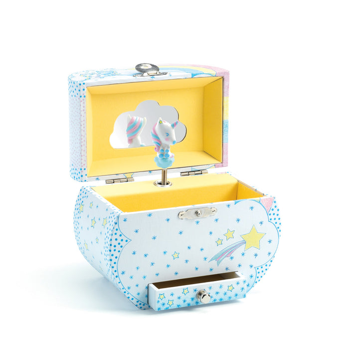 A pastel-colored jewelry box with a star and cloud design, open to reveal a yellow interior, a mirror, and a spinning unicorn figurine inside. A small drawer is visible at the bottom front of the box.