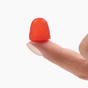 A hand holding a small WonderCalm - Super Mushroom Gummy by Plant People against a white background.