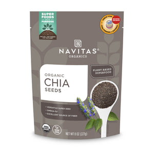 A gray and white Navitas Organics Organic Chia Seeds package, 8 oz., highlights its versatile benefits—omega-3s, protein, and fiber. It features a spoonful of seeds, chia plants, and carries organic and non-GMO labels.