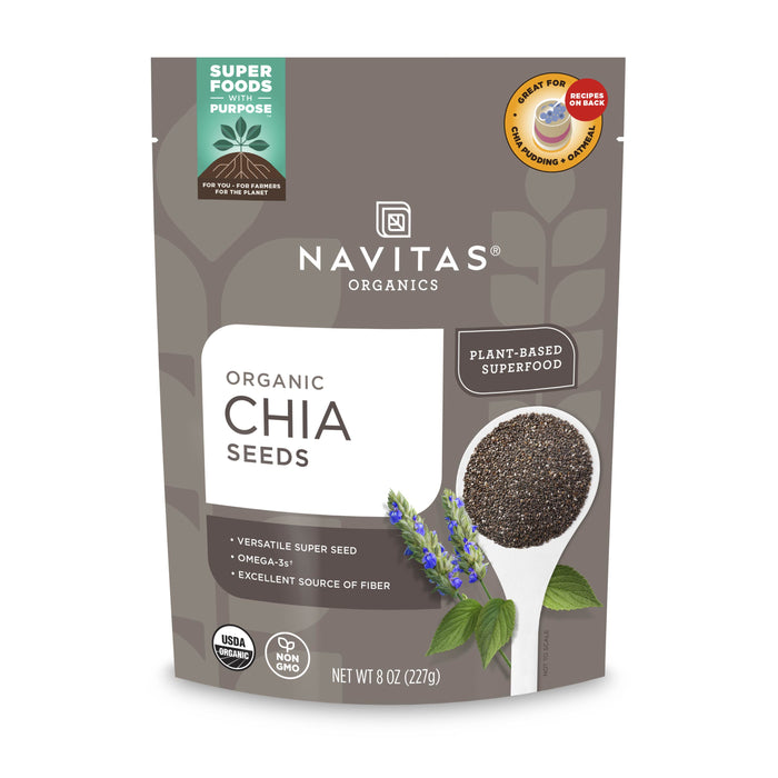 A gray 8 oz (227g) bag of Navitas Organics Organic Chia Seeds, displaying chia seeds on a white spoon with a blue chia flower, and labeling it as a plant-based superfood, USDA organic, and non-GMO.