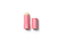 A pink tube of Axiology vegan lip balm with the cap removed and placed beside it on a white background. The tube features small white heart designs and white text.