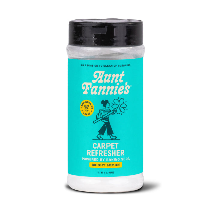 A container of Aunt Fannies Carpet Refresher in Bright Lemon scent, featuring a teal label with a cartoon person holding a flower, and text indicating its powered by baking soda.