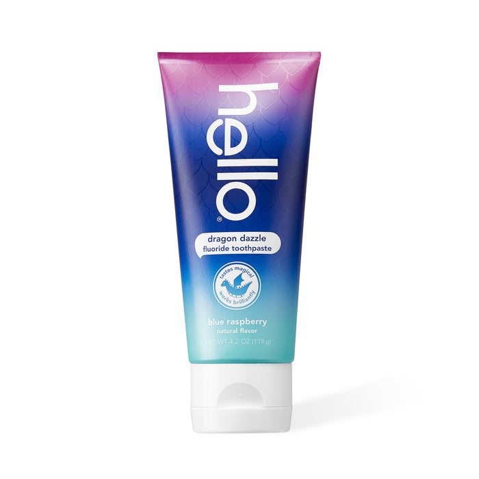 A tube of Hello dragon dazzle fluoride toothpaste in blue raspberry flavor. The tube is purple and blue with scale patterns and white text, standing upright on a white background.