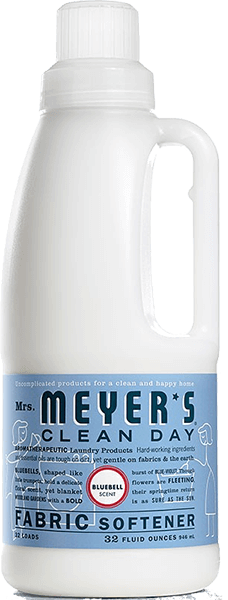 A white bottle of Mrs. Meyer’s Clean Day fabric softener with a blue label featuring product details and a red circle indicating bluebell scent. The bottle contains 32 fluid ounces for 32 loads.