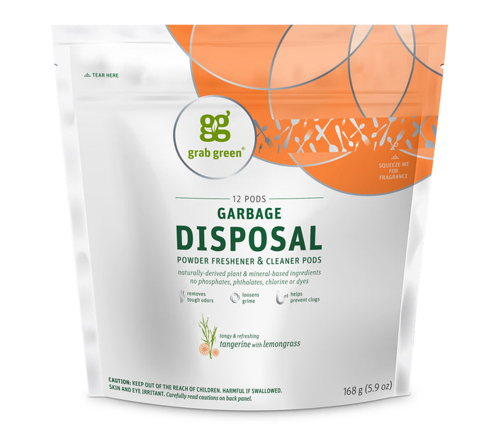 A white and orange pouch of Grab Green Garbage Disposal Powder Freshener & Cleaner Pods, tangerine with lemongrass scent, containing 12 pods, with product details and caution label on the front.