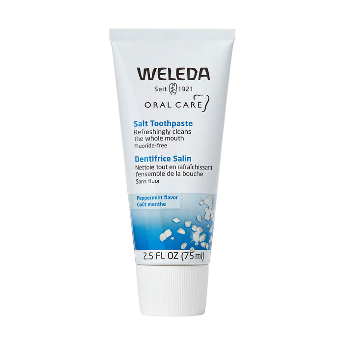 A white tube of Weleda Salt Toothpaste, featuring blue accents and images of salt crystals. The tube is labeled as fluoride-free, peppermint flavor, and contains 75 ml (2.5 fl oz).