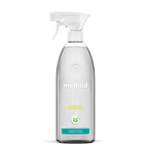An 828 ml (28 fl oz) Method Daily Shower Spray features a clear bottle with a white nozzle. The label highlights its natural cleansing power, stating Cleans without having to rinse, ideal for effortless shower maintenance and soap scum removal.