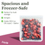 A transparent, food-safe (re)zip Reusable Leakproof Gallon Bag filled with mixed berries rests on a pink surface. The spacious 128 fl oz bag is airtight and ideal for freezer bulk storage.