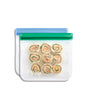 A (re)zip Reusable Sandwich & Lunch Bag with a green seal holds nine pinwheel sandwich rolls. Another empty eco-friendly (re)zip bag with a blue seal is partially visible behind it.