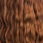 Close-up of long, wavy red-brown hair with a shiny texture, maintained by The Balancer Shampoo Bar from NOT!CE Hair Co., which uses plastic-free care to tame frizzy locks and highlights natural waves under soft lighting.
