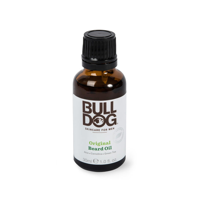 A brown 30ml bottle of Bulldog Skincare for Men Original Beard Oil with a black cap. The label is white with brown and green text, listing aloe, camelina, and green tea as ingredients.