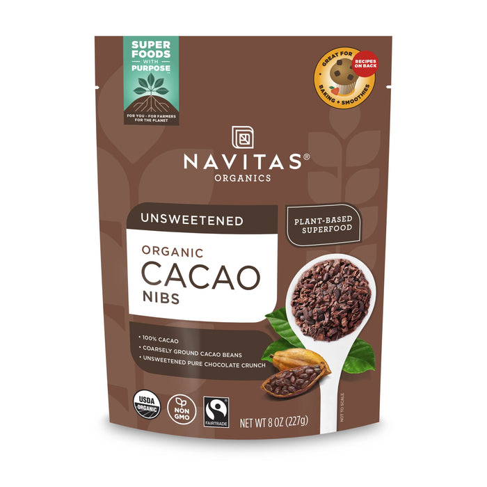 A brown pouch of Navitas Organics Unsweetened Organic Cacao Nibs, featuring images of cacao nibs in a spoon, cacao beans, leaves, and labeling for USDA Organic, Non-GMO, and Superfoods Purpose.