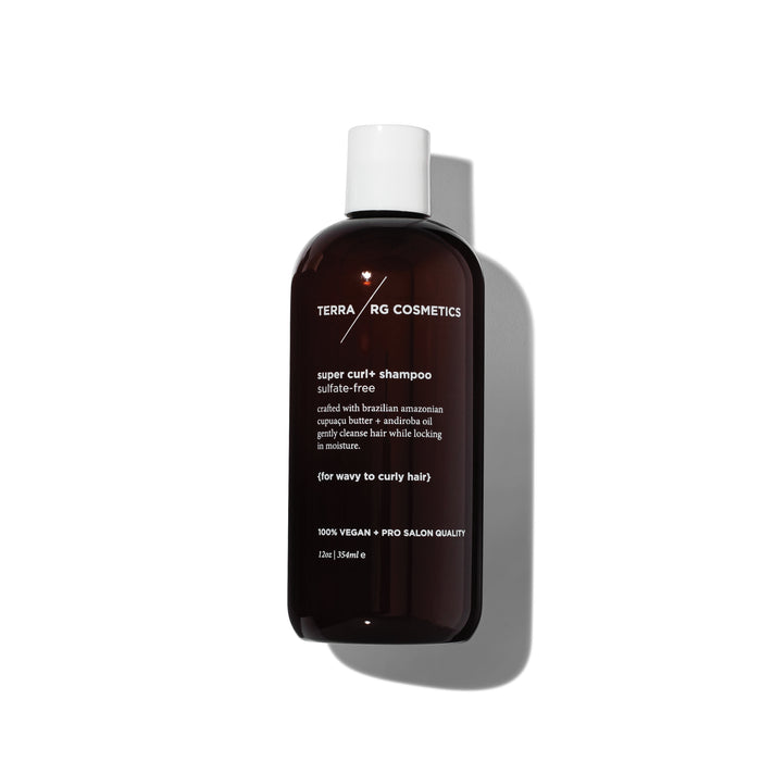 A dark brown bottle of TERRARG COSMETICS super curl+ shampoo with a white cap, shown against a white background. The label highlights that it is sulfate-free and designed for wavy to curly hair.