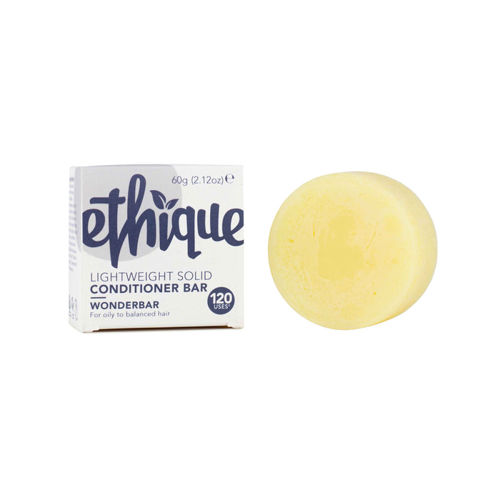 A yellow, round conditioner bar sits next to its white and purple box labeled Ethique Lightweight Solid Conditioner Bar, Wonderbar, for oily to balanced hair, 60g (2.12oz), 120 uses.