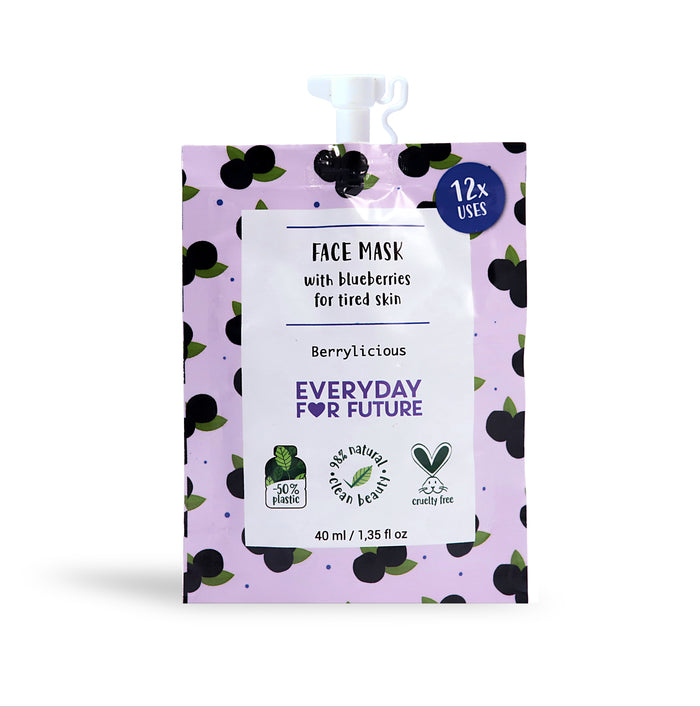 A purple pouch of Berrylicious Everyday For Future face mask with blueberries for tired skin, featuring black berry graphics, eco-friendly and cruelty-free symbols, and text highlighting 12 uses and 50% less plastic.