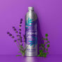 A silver bottle of Grove Co. dish soap with lavender blossom and thyme, surrounded by sprigs of lavender and thyme, against a purple background. The bottle features purple and teal leaf designs.