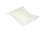 A small white mesh bag of nylon netting lies against a black background. Its pillow-like shape hints it might resemble Fresh Waves Odor Removing Packs for small spaces, designed to freshen areas with natural active ingredients.