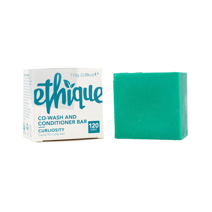 A turquoise square Ethique co-wash and conditioner bar stands next to its white and teal packaging, which reads Ethique Co-Wash and Conditioner Bar Curliosity, 120 uses, 110g.