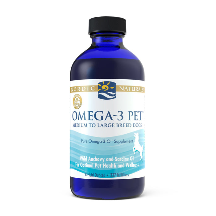 A blue bottle of Nordic Naturals Omega-3 Pet oil supplement for medium to large breed dogs, featuring a white label with blue and gold accents and text highlighting wild anchovy and sardine oil.