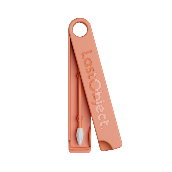 A reusable cotton swab with a white tip is placed inside a peach-colored, rectangular case labeled LastObject. The case has a rounded corner with a hole for hanging.