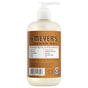 A bottle of Mrs. Meyer's Hand Soap with a pump, featuring a brown label and a garden-inspired formula with essential oils. Free of parabens and phthalates, it perfectly complements your favorite Mrs. Meyer's products.