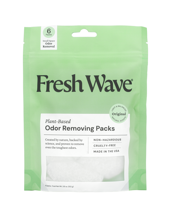 A green and white package labeled Fresh Wave Plant-Based Odor Removing Packs. The packaging highlights features like “Non-Hazardous,” “Cruelty-Free,” “Made in the USA,” and contains 6 packs for odor removal.