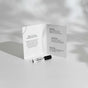 A perfume sample vial labeled SANTEL lies in front of an open card describing the scent’s top, heart, and base notes, all set against a bright, softly shadowed surface.