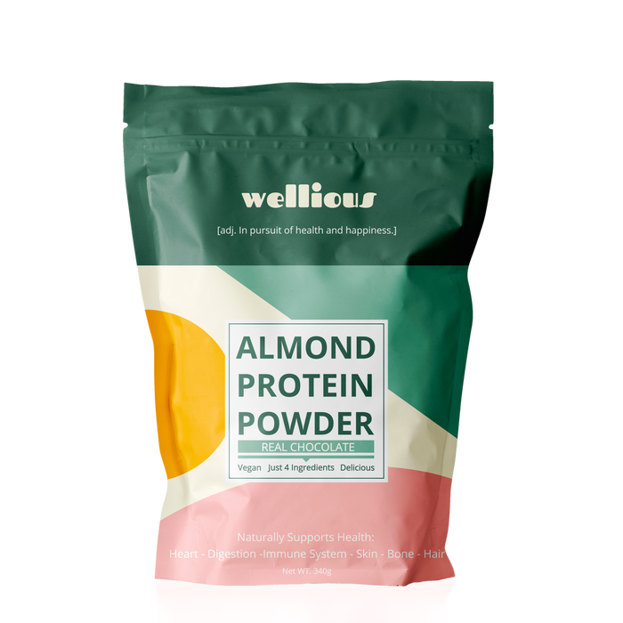 A colorful pouch labeled Wellious Almond Protein Powder, Real Chocolate. Highlights include: vegan, just 4 ingredients, delicious; supports heart, digestion, immune system, skin, bone, and hair; 340g.