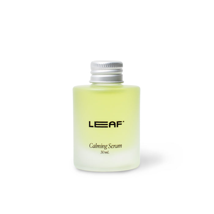 A small frosted glass bottle with a silver cap, filled with light yellow liquid. The label reads LEAF Calming Serum 30 mL. The bottle is centered on a plain white background.
