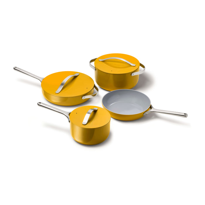 A four-piece yellow cookware set with silver handles, including a frying pan, a saucepan with lid, and two lidded pots, displayed on a white background.