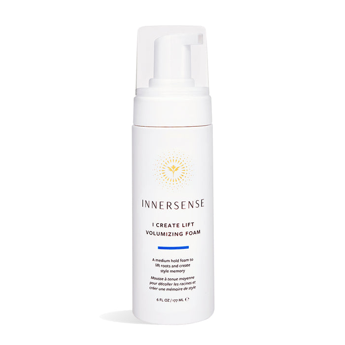 A white bottle of Innersense I Create Lift Volumizing Foam with a pump dispenser, featuring gold sunburst design and blue text describing it as a medium hold foam for lifting roots and creating volume.