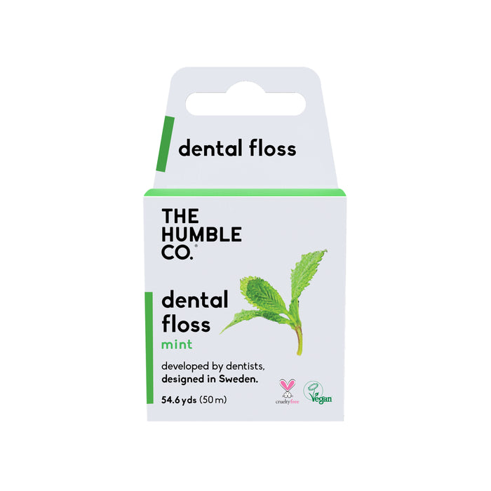 The Humble Co.s mint-flavored dental floss in white packaging with green accents features a mint leaf and cruelty-free, vegan logos. Made in Sweden, its ideal for dental hygiene and measures 54.6 yards (50 meters).