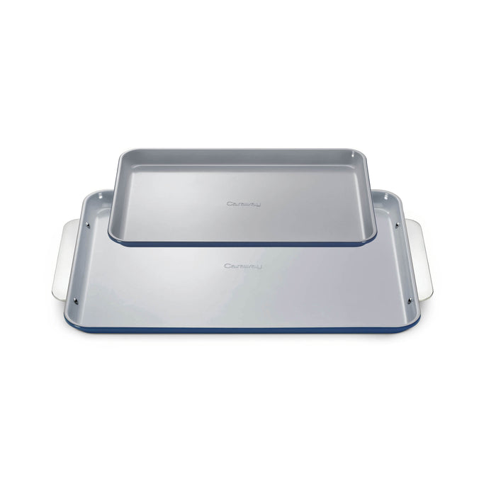 Two rectangular baking sheets, one smaller and stacked on top of a larger one, both light gray with silver handles, placed on a white background.