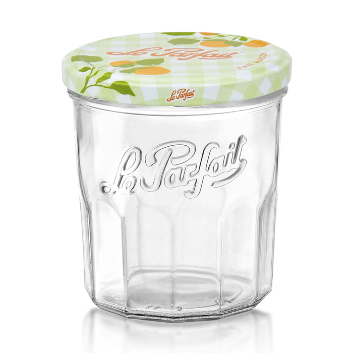 A clear glass jar with Le Parfait embossed on the front, topped with a decorative lid featuring a fruit pattern and the Le Parfait logo on a light green checkered background.