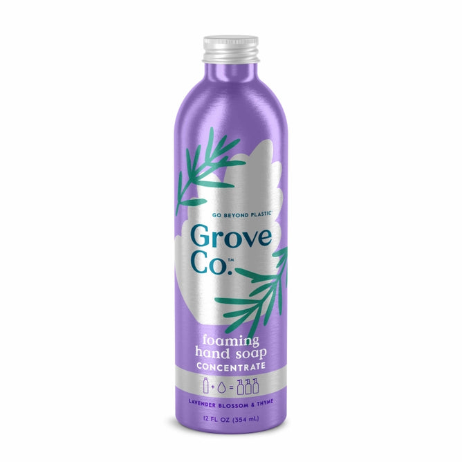 Grove Co.s Foaming Hand Soap Refill in a tall purple aluminum bottle holds 12 fl oz (354 ml) and features lavender, blossom, and thyme scent. Decorated with green leaf designs, it promotes sustainable packaging with the message Go Beyond Plastic.