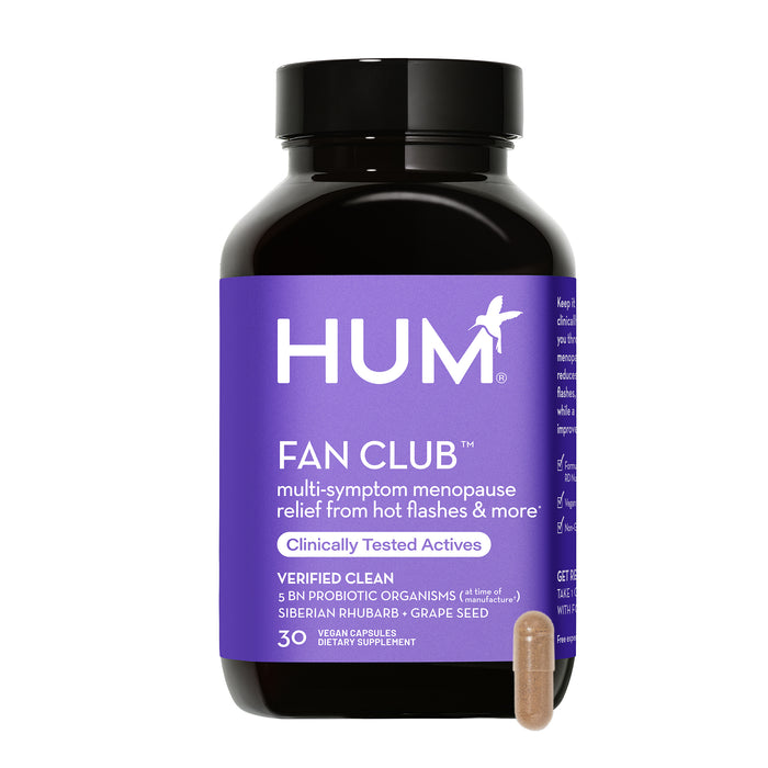 A bottle of HUM Fan Club dietary supplement for menopause relief, featuring a purple label with white text, and a single beige capsule shown in front of the bottle.