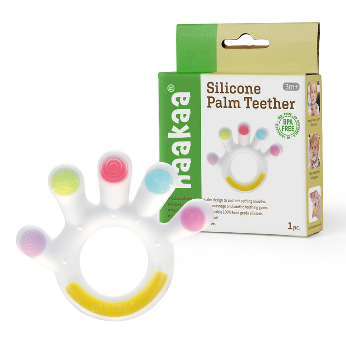 A silicone palm-shaped teether with colorful tips and a yellow section, shown next to its green and beige packaging labeled Haakaa Silicone Palm Teether for ages 3 months and up.
