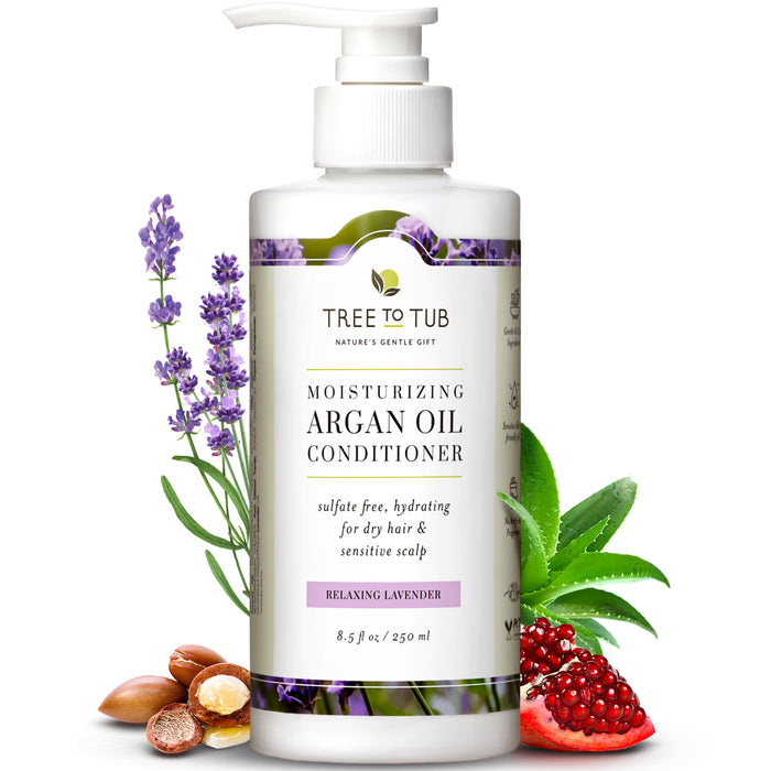 A bottle of Tree to Tub Moisturizing Argan Oil Conditioner, labeled Relaxing Lavender, surrounded by lavender flowers, argan nuts, pomegranate, shea butter, and aloe vera leaves.