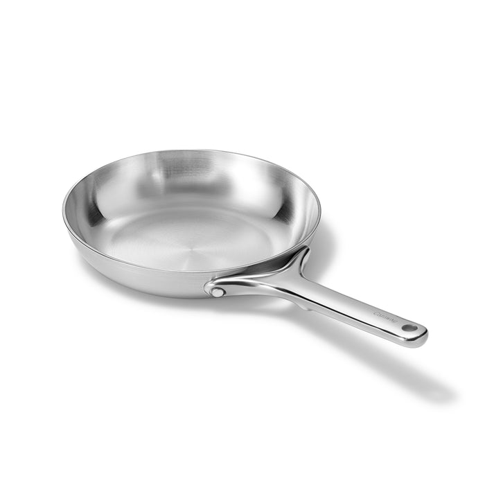 A stainless steel frying pan with a shiny finish and a long handle, placed on a white background.
