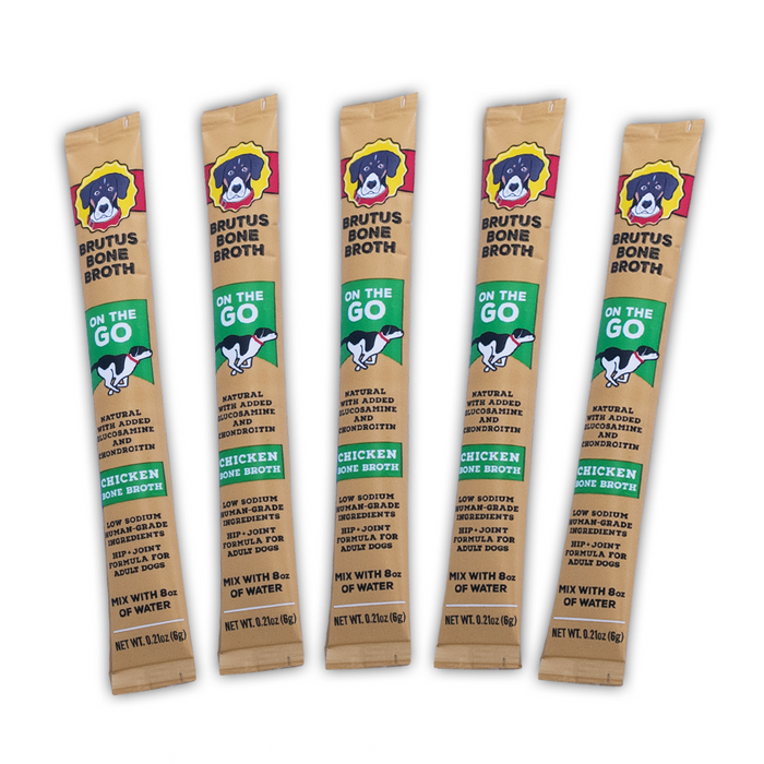 Five Brutus Bone Broth On the Go chicken bone broth powder sticks for dogs, each in tan packaging with cartoon dog logo and green accents, arranged vertically against a white background.