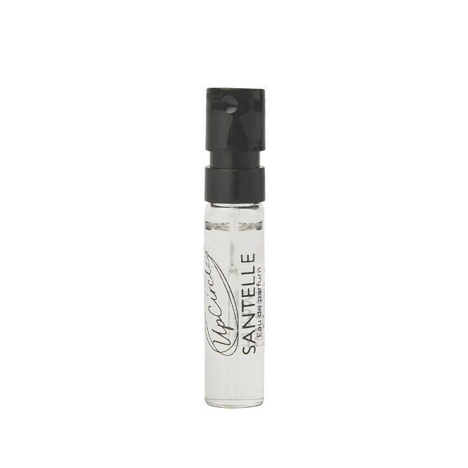 A small, clear spray vial of SANTELLE Eau de Parfum with a black cap and Opacity SANTELLE text printed on the bottle, shown against a white background.