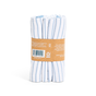 A bundle of Grove Co. Organic Cotton Striped Kitchen Towels, featuring white fabric with thin blue stripes, is tied with a brown cardboard sleeve displaying quick-drying organic cotton and care symbols. These essential towels stand upright against a pristine white background.