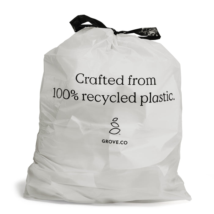A white trash bag with black drawstrings features the text Crafted from 100% recycled plastic. and a small logo with GROVE.CO below it.