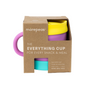 A purple silicone cup with a pink handle, yellow lid, and turquoise base, packaged in a brown cardboard box labeled “morepeas The Everything Cup for every snack & meal.”.