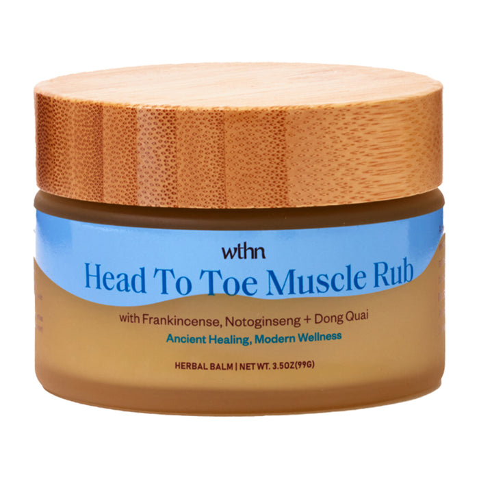 A jar of WTHN Head To Toe Muscle Rub with a bamboo lid. The label highlights ingredients like frankincense, notoginseng, and dong quai, and describes the product as “Ancient Healing, Modern Wellness.”.