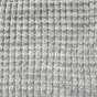 Close-up of the AU Baby Popcorn Blanket in Moon Stone, a light gray superfine merino baby blanket with a textured, waffle-like knit pattern.