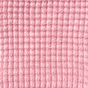 Close-up of The Popcorn Blanket - Pink Quartz, a pink, plant-dyed merino knit fabric with a raised, grid-like popcorn texture.